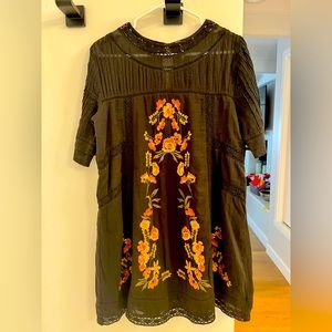 Black dress with embroidery.